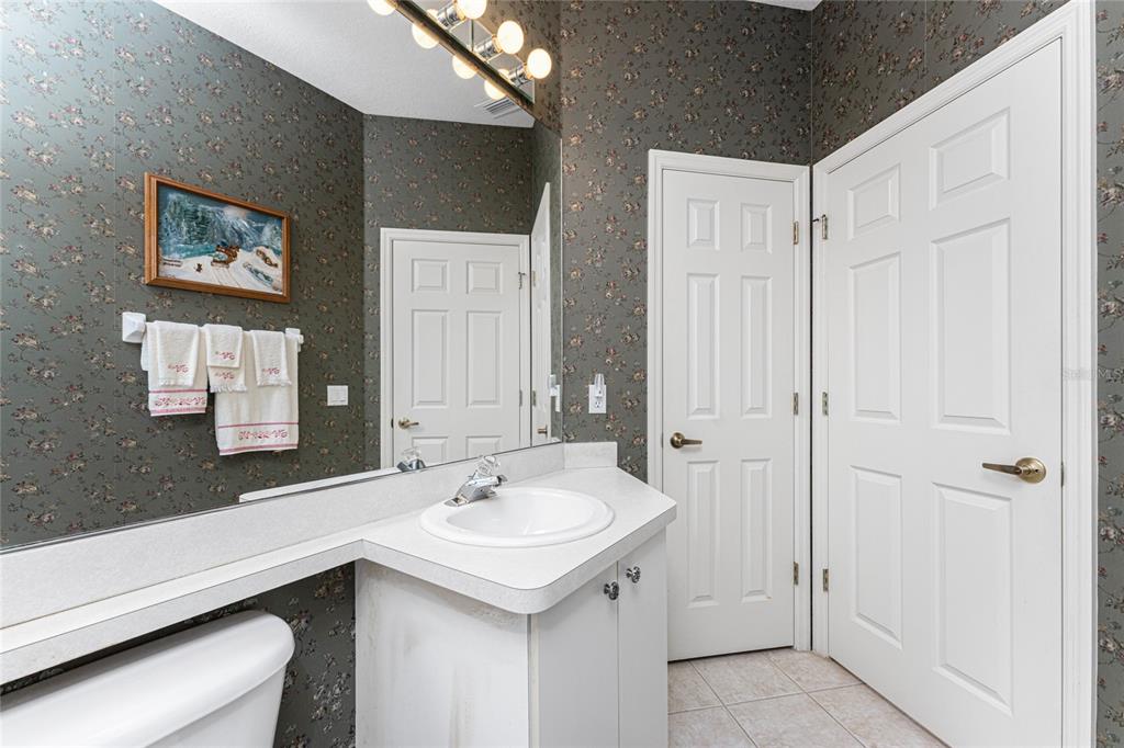 10214 Windsong Road Punta Gorda, FL 33955 - Photo 27 of 68 a bathroom with a sink and a mirror