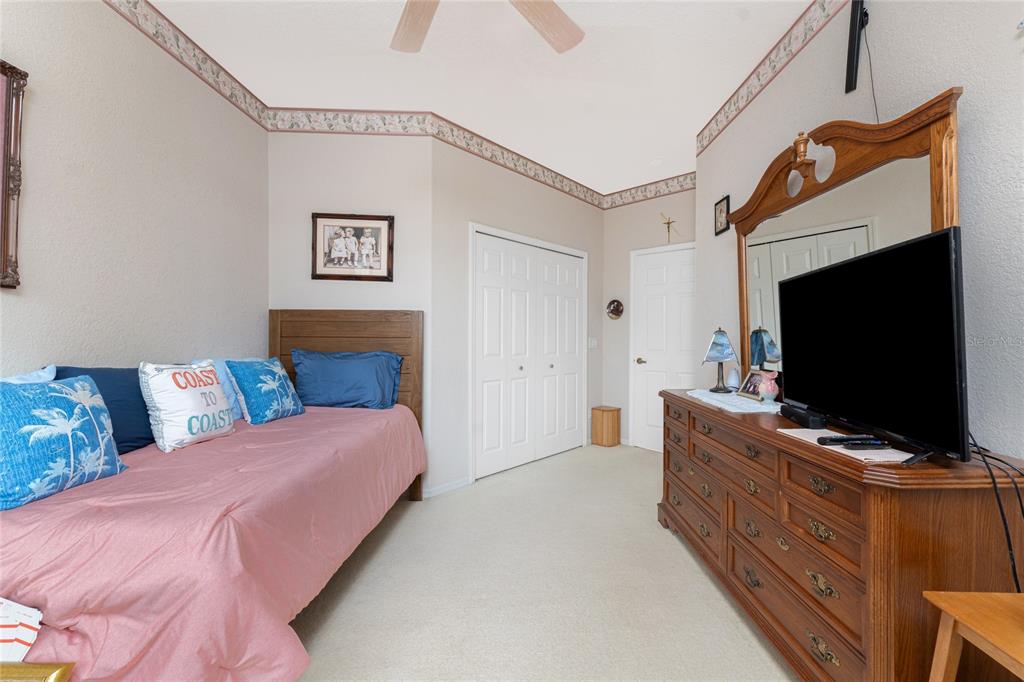10214 Windsong Road Punta Gorda, FL 33955 - Photo 29 of 68 a bedroom with a bed and a flat screen tv
