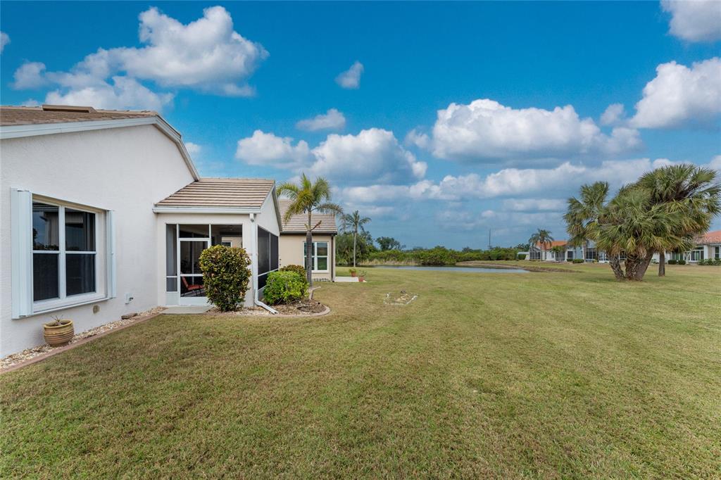 10214 Windsong Road Punta Gorda, FL 33955 - Photo 34 of 68 a front view of a house with a yard and potted plants