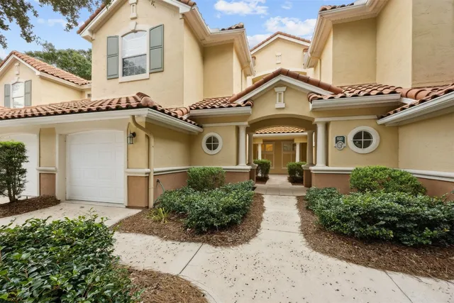a view of a street with a white house