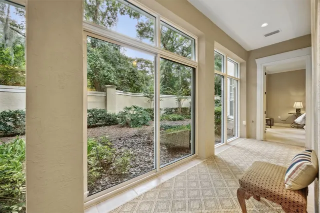 a bedroom with furniture and large windows