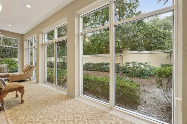 a view of a room that has a bed and glass door