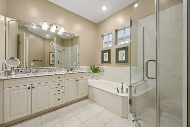 a bathroom with a granite countertop sink a large mirror and a shower