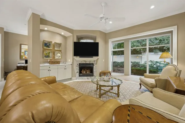 a living room with furniture a fireplace and a flat screen tv