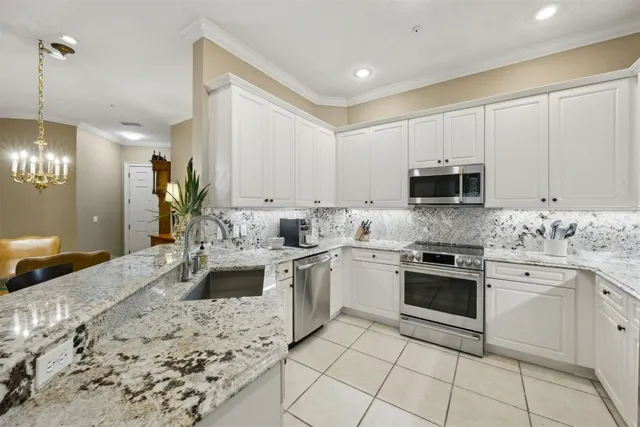 a kitchen with a sink stove and white cabinets
