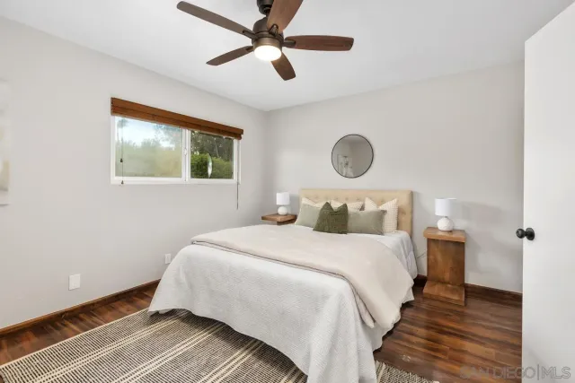 a bedroom with bed and a window