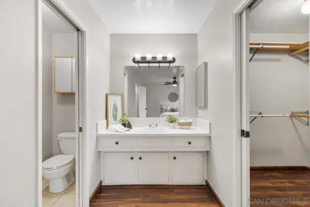 a bathroom with a sink a toilet and a mirror