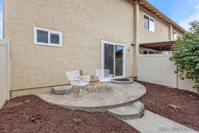 a view of a house with backyard and sitting area