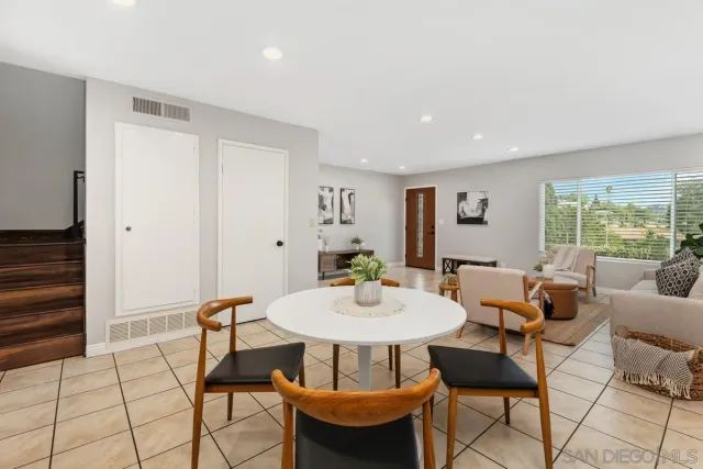 a dining room with furniture and window