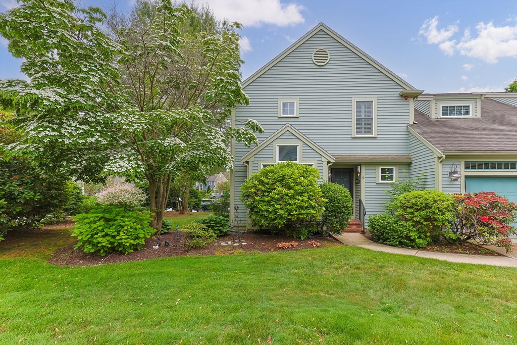 2 Darby Point, Unit 2 Mashpee, MA 02649 - Photo 1 of 42 a front view of a house with a garden and plants