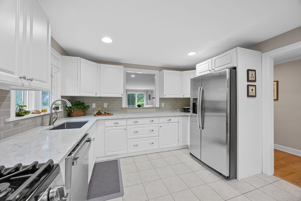 2 Darby Point, Unit 2 Mashpee, MA 02649 - Photo 11 of 42 a kitchen with stainless steel appliances granite countertop a refrigerator and a stove top oven
