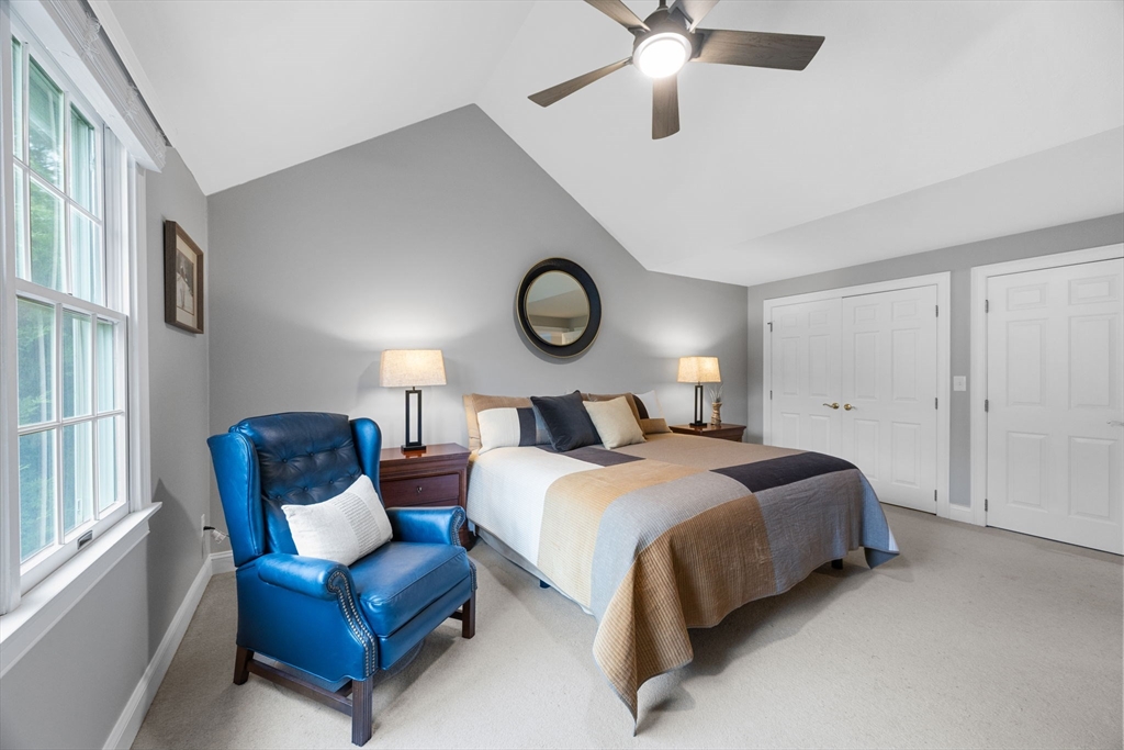 2 Darby Point, Unit 2 Mashpee, MA 02649 - Photo 20 of 42 a bedroom with bed and a chandelier