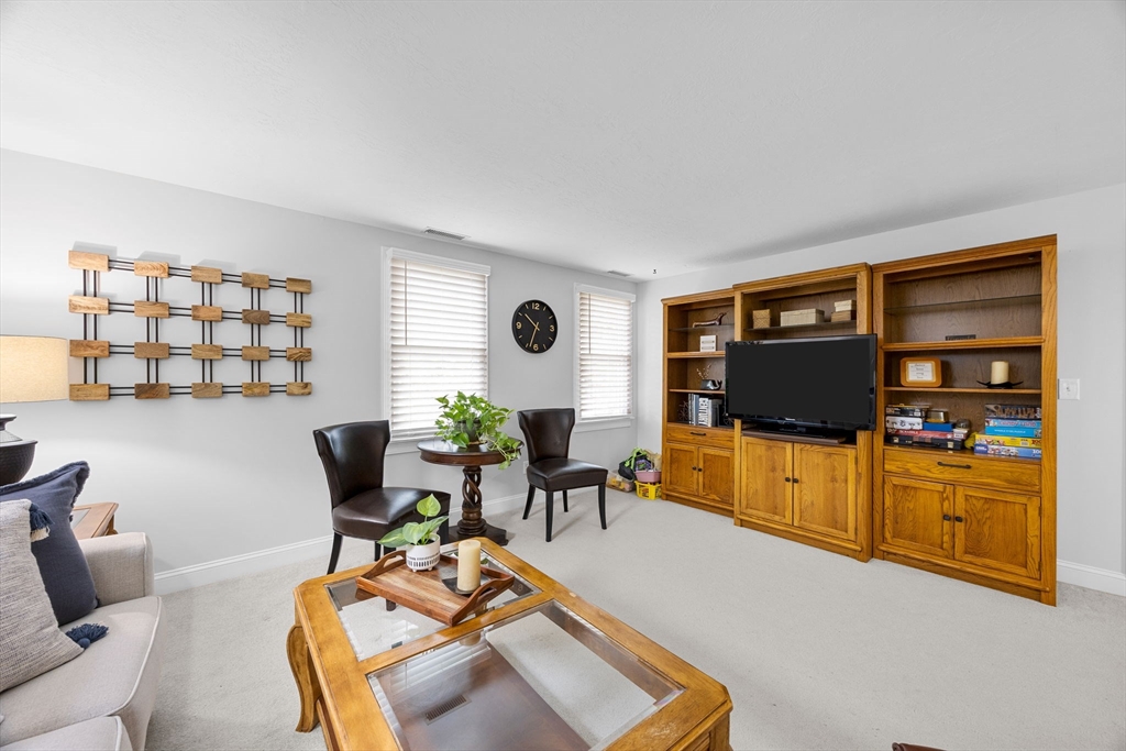 2 Darby Point, Unit 2 Mashpee, MA 02649 - Photo 23 of 42 a living room with furniture and a flat screen tv