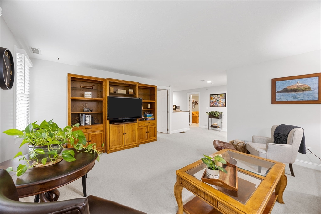 2 Darby Point, Unit 2 Mashpee, MA 02649 - Photo 24 of 42 a living room with furniture and a flat screen tv