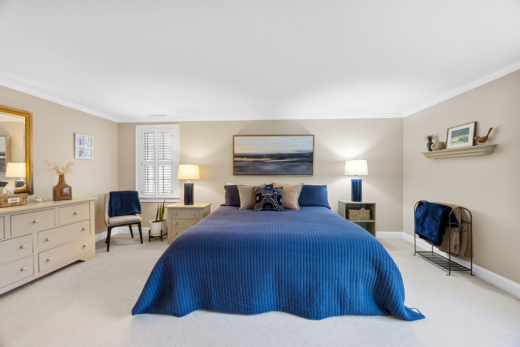 2 Darby Point, Unit 2 Mashpee, MA 02649 - Photo 31 of 42 a bedroom with a bed and furniture