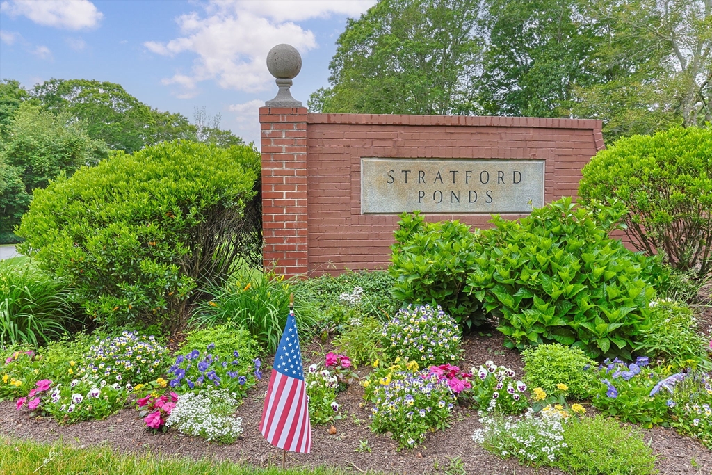 2 Darby Point, Unit 2 Mashpee, MA 02649 - Photo 39 of 42 a sign that is in front of flowers