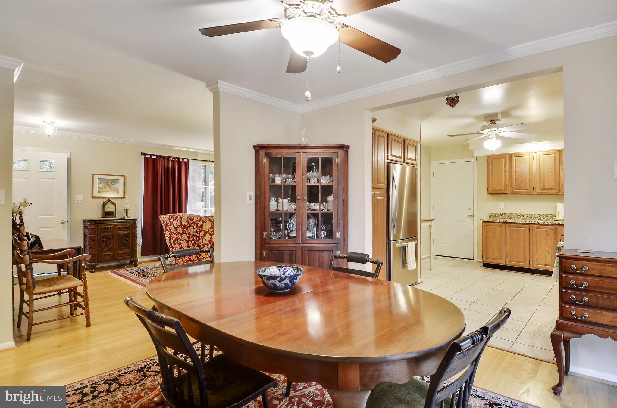 18727 Bloomfield Road Olney, MD 20832 - Photo 9 of 25 a view of a dining room with furniture and wooden floor