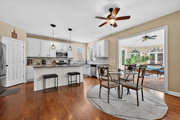 a view of kitchen with cabinets table and chairs