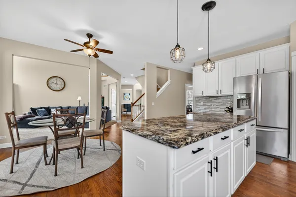 a view of kitchen with cabinets table and chairs