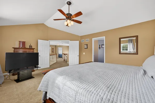 a bedroom with a bed and a lamp