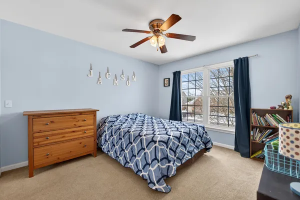 a bedroom with a bed and a dresser