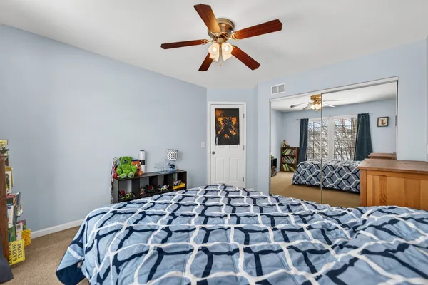 a bedroom with bed and a window