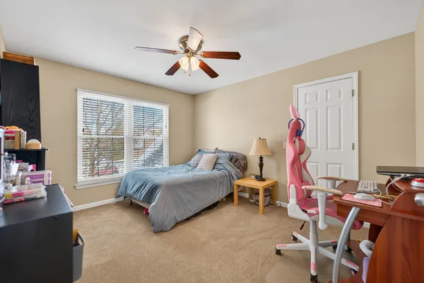 a bedroom with a bed and a chair