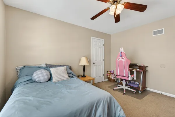 a bedroom with a bed and a chandelier