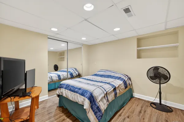 a room with a wooden floor and a window