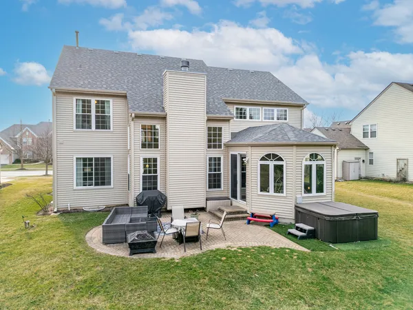 a backyard of a house with barbeque oven fire pit and chairs