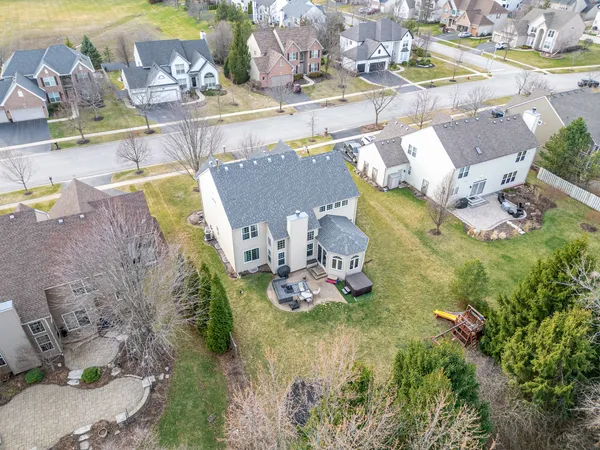 an aerial view of a house with a yard