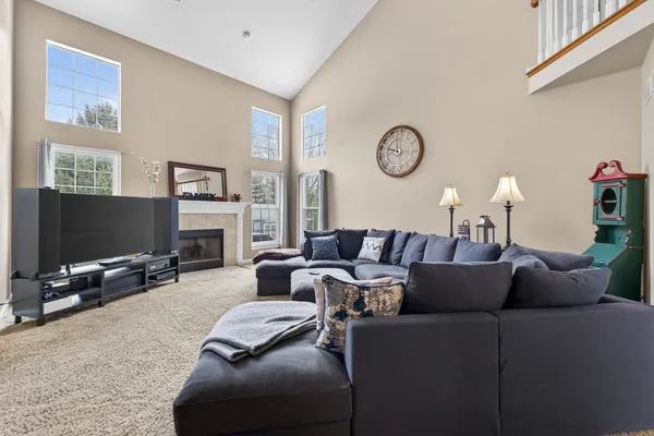 a living room with furniture a fireplace and a flat screen tv