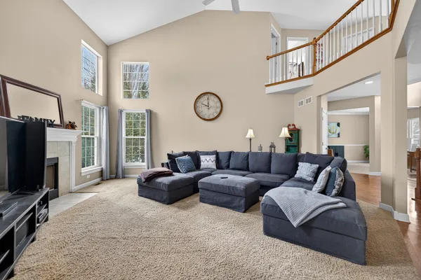 a living room with fireplace furniture and a flat screen tv