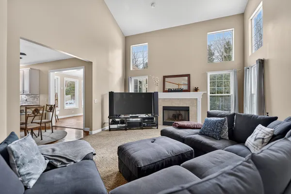 a living room with furniture a fireplace and a flat screen tv