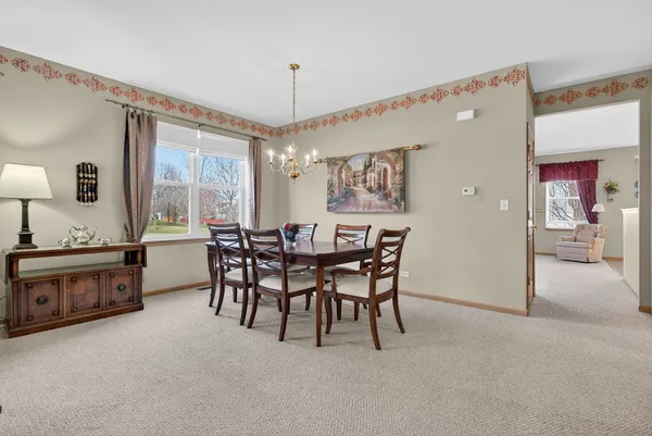 a living room with furniture and a ceiling fan