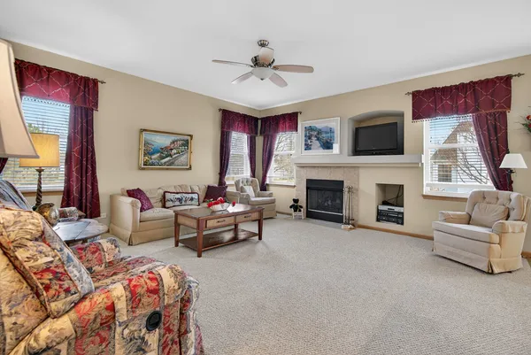 a living room with furniture and a fireplace