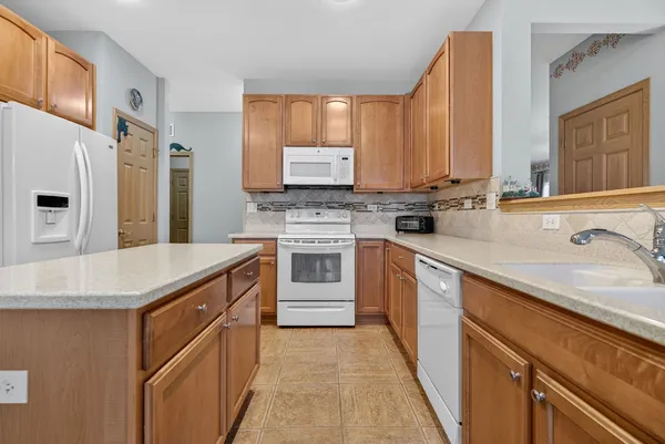 a kitchen with a stove a refrigerator and a table