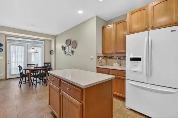 a kitchen that has a lot of cabinets in it and wooden floors