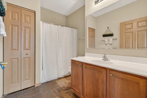 a spacious bathroom with a granite countertop sink mirror and double