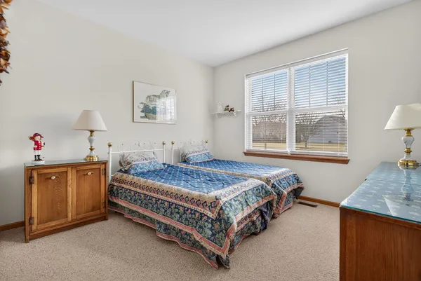 a bedroom with bed and wooden floor