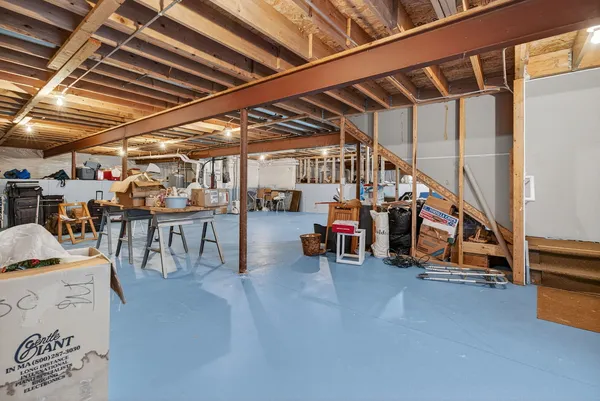 a room with lots of furniture and a car