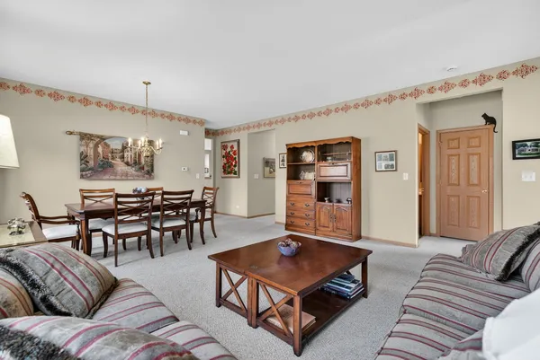 a living room with furniture and a lamp