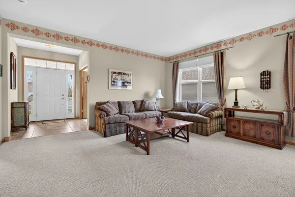a view of a dining room with furniture and window