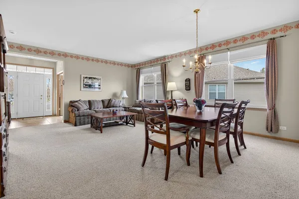 a dining room with furniture and window