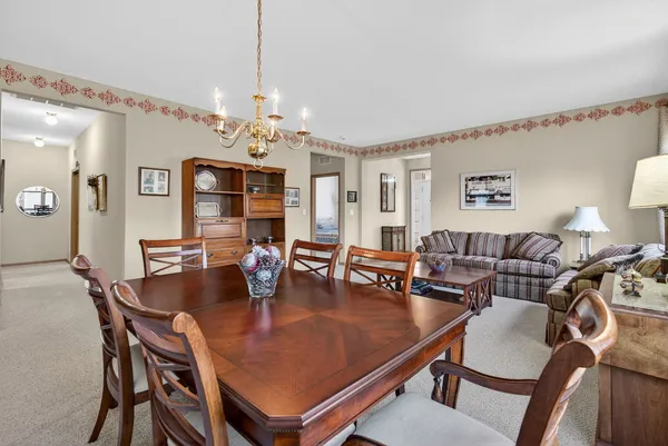 a view of a dining room with furniture window and chandelier