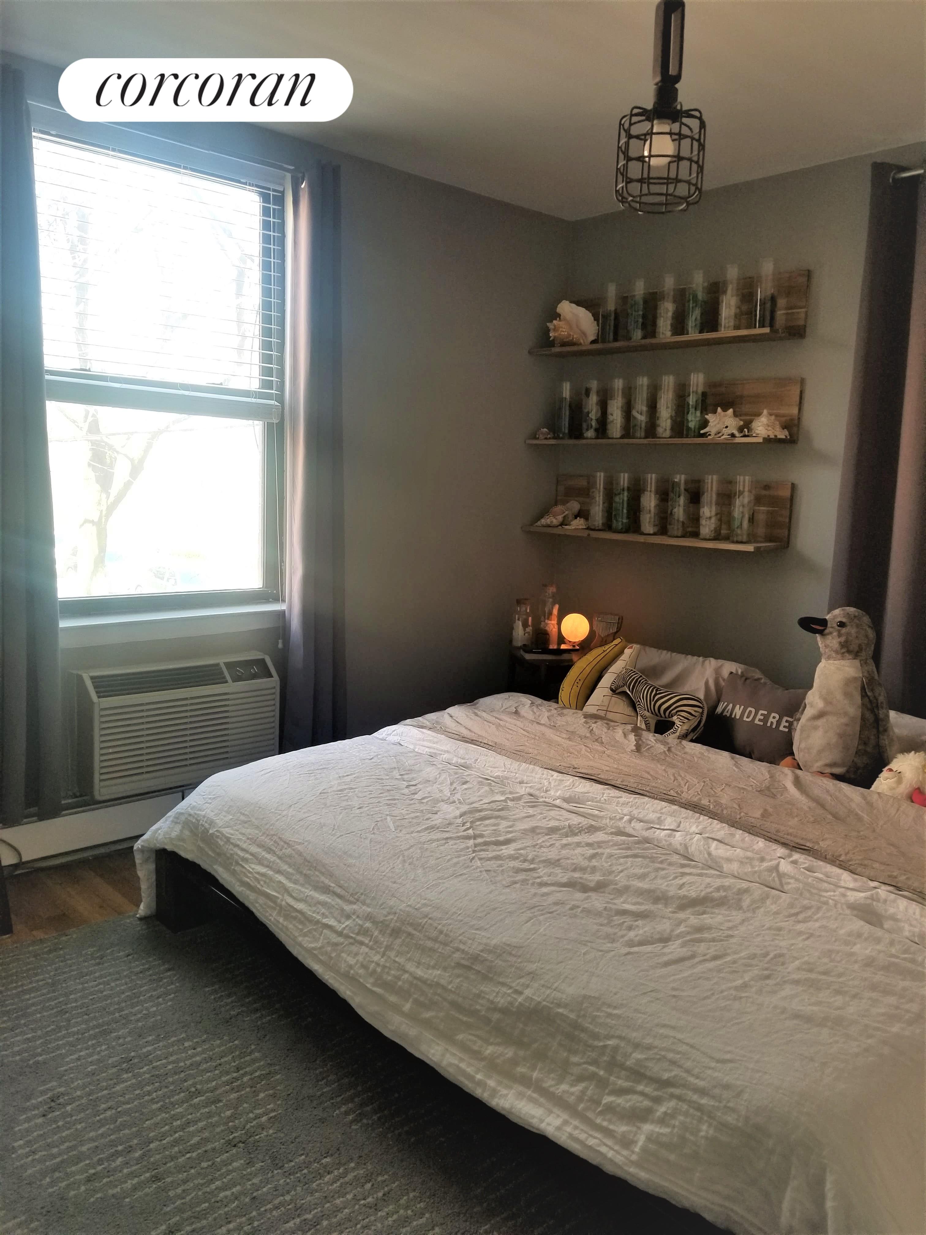 254 Bedford Avenue, Unit 2 Brooklyn, NY 11249 - Photo 1 of 1 a bedroom with a bed wooden floor and window