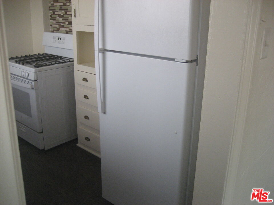 105 West 106th Street, Unit 109 Los Angeles, CA 90003 - Photo 16 of 19 a kitchen with a refrigerator and a stove