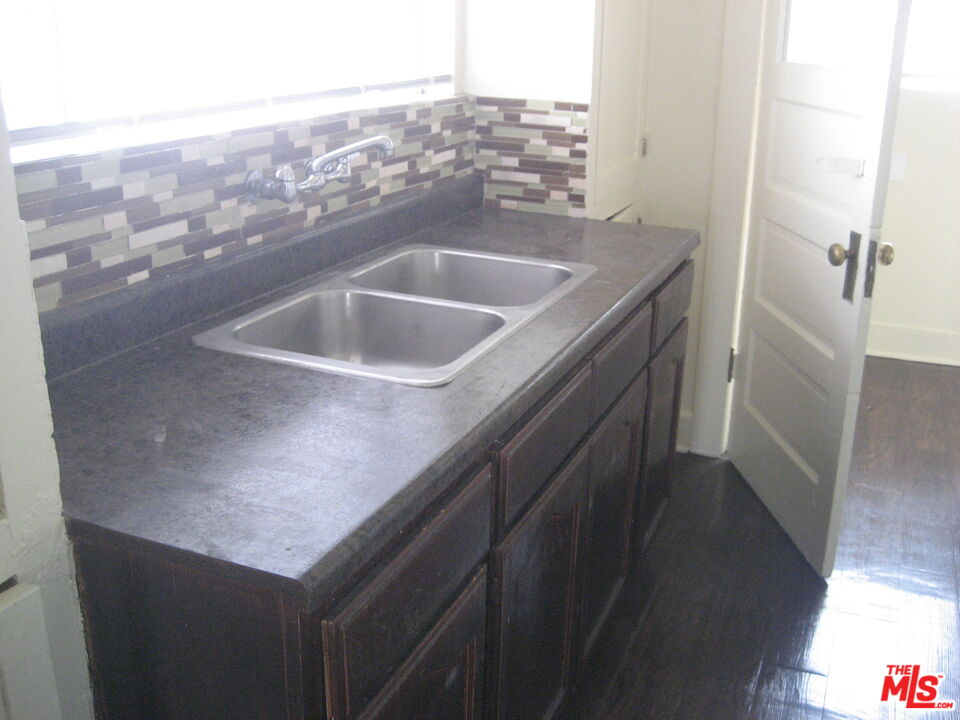 105 West 106th Street, Unit 109 Los Angeles, CA 90003 - Photo 18 of 19 a bathroom with a sink and vanity