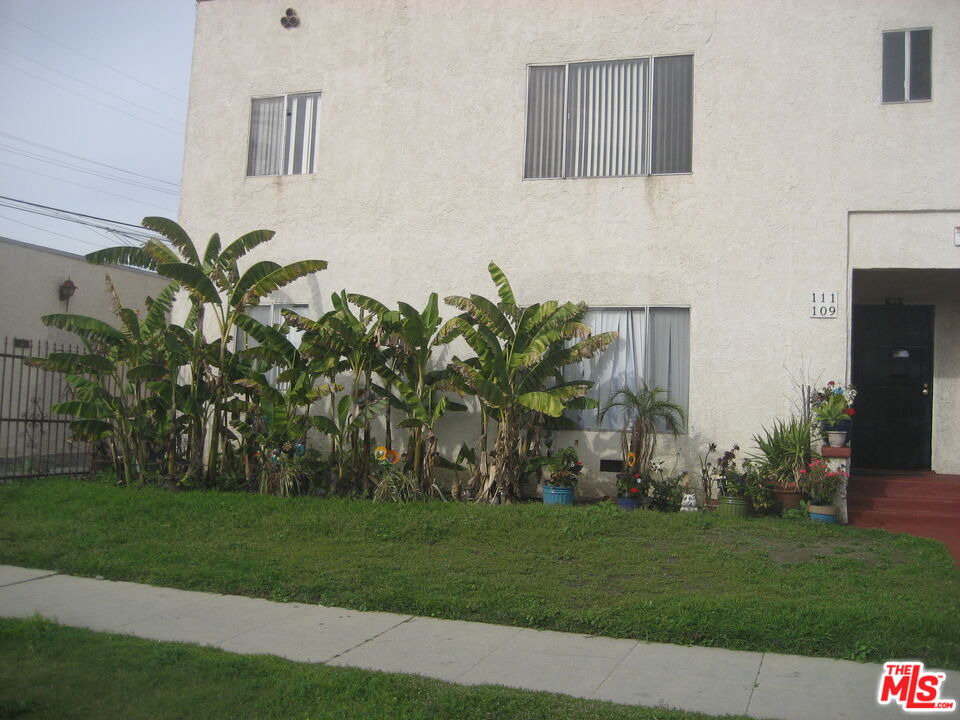 105 West 106th Street, Unit 109 Los Angeles, CA 90003 - Photo 2 of 19 a view of a house with a garden