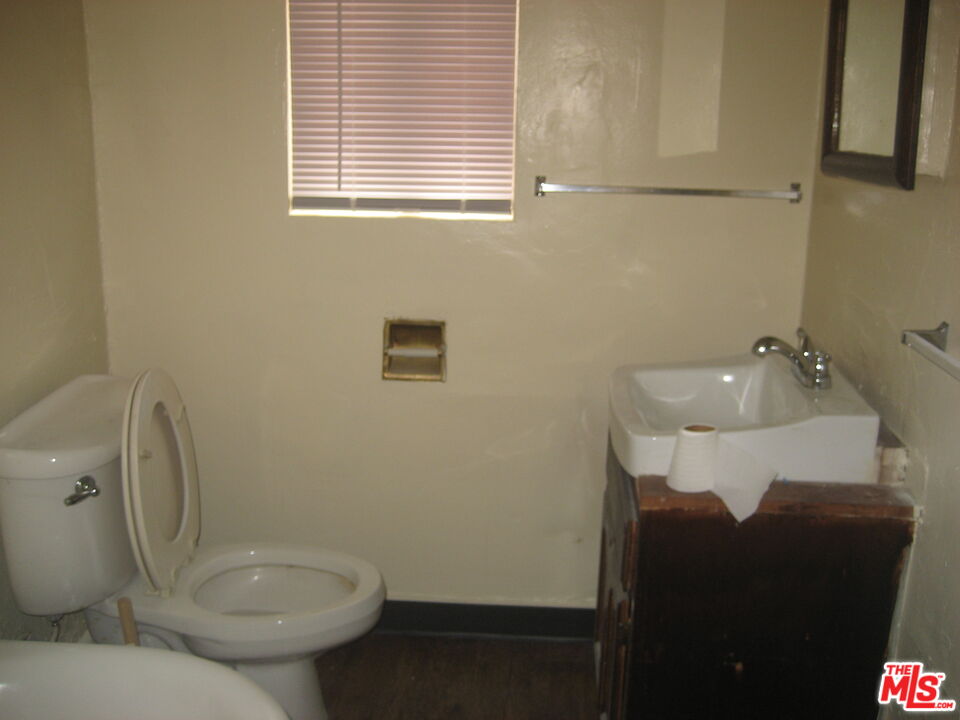 105 West 106th Street, Unit 109 Los Angeles, CA 90003 - Photo 8 of 19 a bathroom with a toilet and a sink